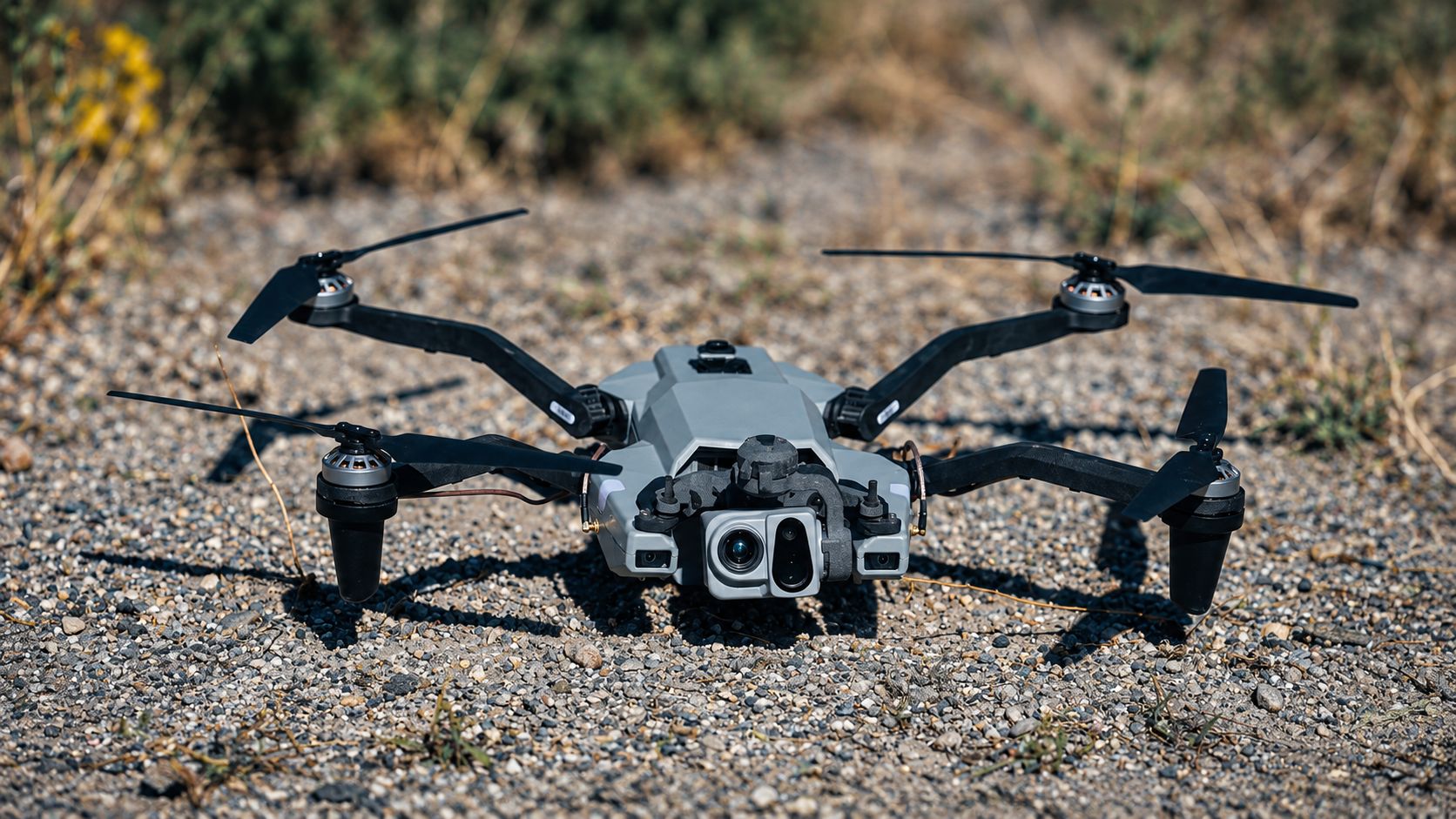 Quadcopter with sensor gimbal resting on gravel