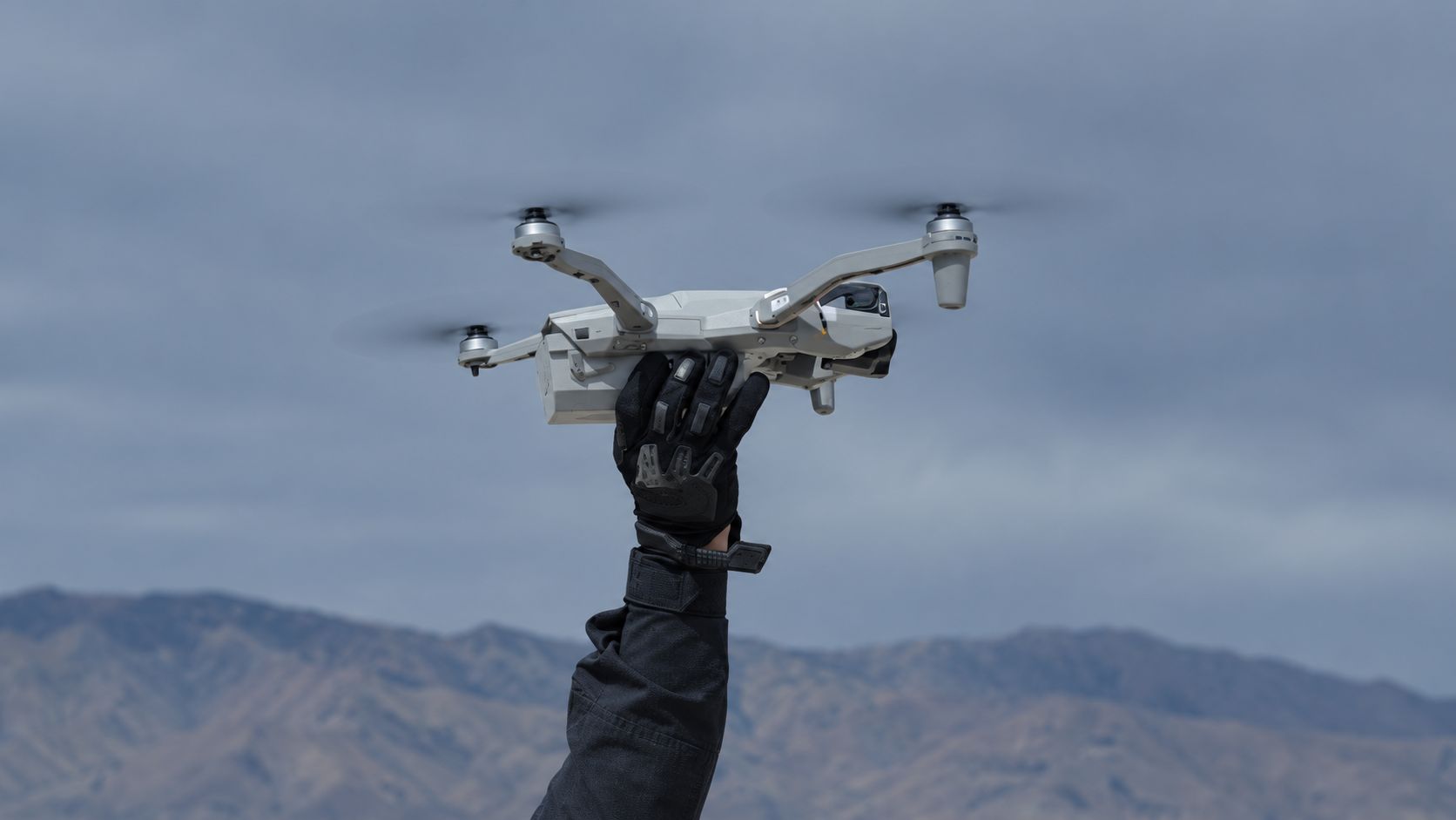 Operator holding a quadcopter aloft