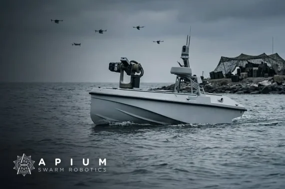 Apium Swarm Robotics logo over an uncrewed surface vessel with a drone swarm overhead